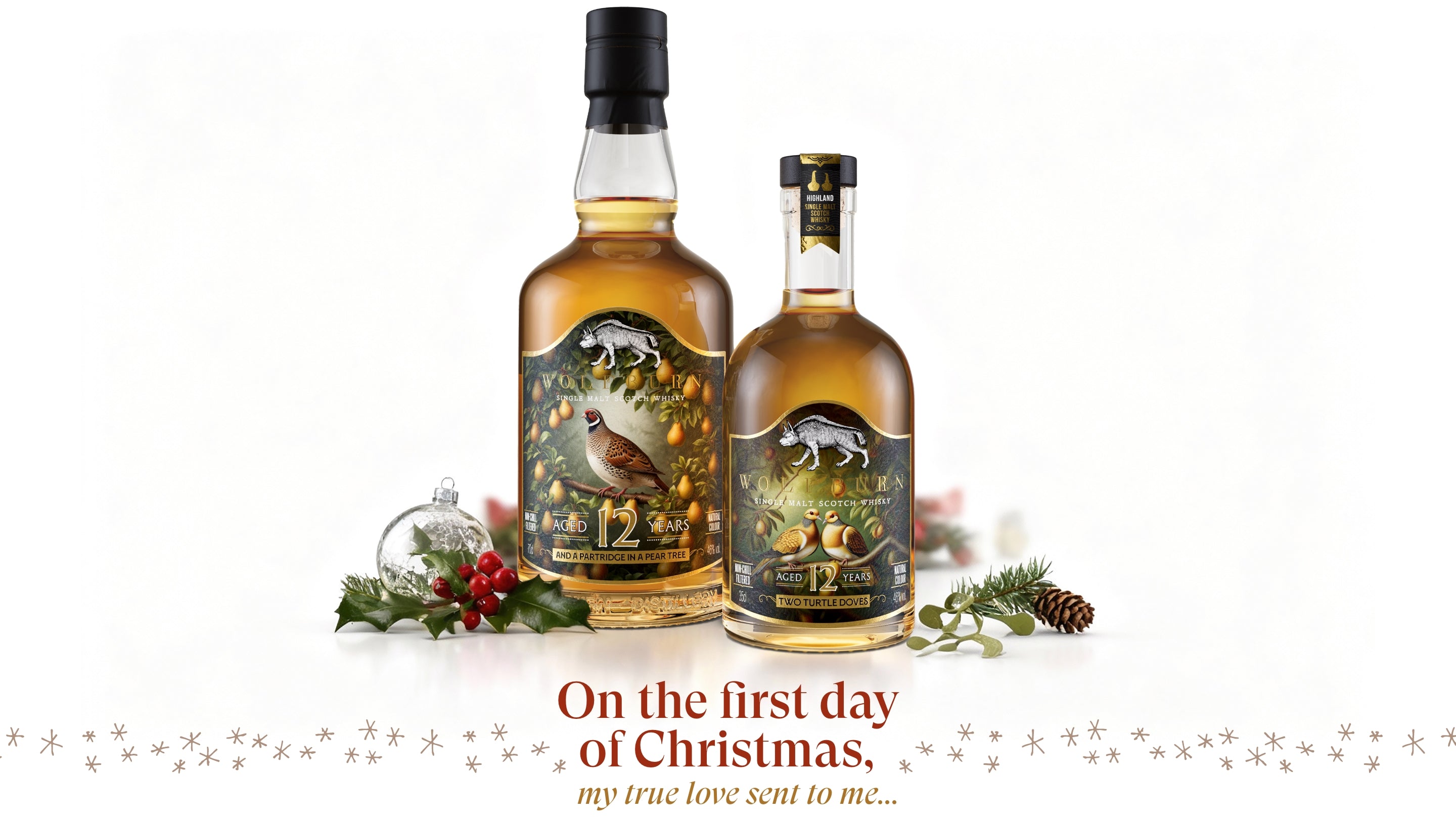 Two bottles of Single Malt whisky with Christmas-themed labels on a white background.