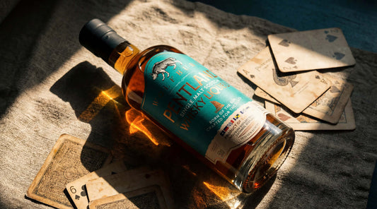 Pentland Whisky Liqueur in the sun with playing cards