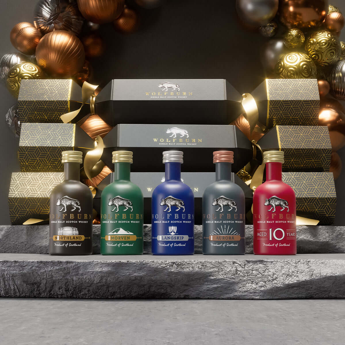 Wolfburn Luxury Christmas Crackers in a bundle of 6, each featuring a 5cl miniature Single Malt Scotch Whisky, festive hat, joke, and iconic Wolfburn pin badge