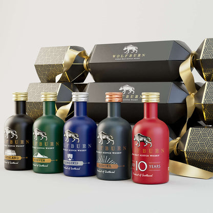 Wolfburn Luxury Christmas Crackers in a bundle of 6, each featuring a 5cl miniature Single Malt Scotch Whisky, festive hat, joke, and iconic Wolfburn pin badge