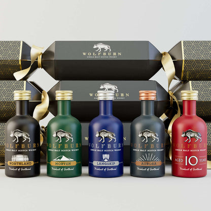 Wolfburn Luxury Christmas Crackers in a bundle of 6, each featuring a 5cl miniature Single Malt Scotch Whisky, festive hat, joke, and iconic Wolfburn pin badge