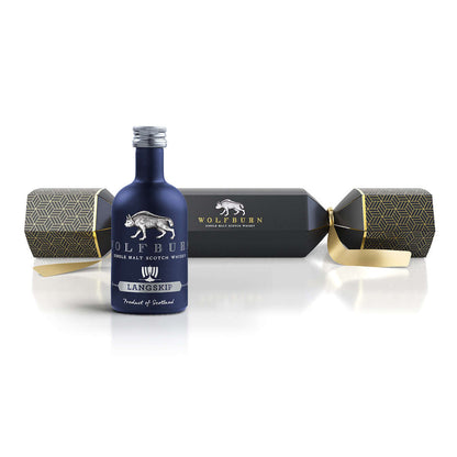 Blue bottle of Wolfburn Langskip whisky with packaging on a white background