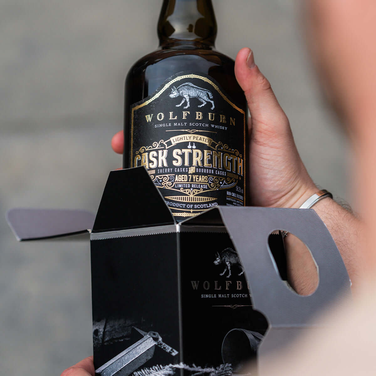 Wolfburn Cask Strength Single Malt Whisky bottle featuring lightly peated aged spirit in a packaging