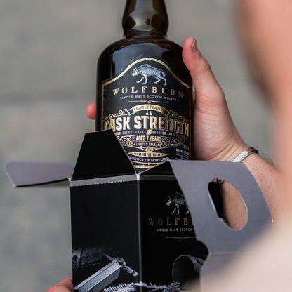 Wolfburn Cask Strength Single Malt Whisky bottle featuring lightly peated aged spirit in a packaging