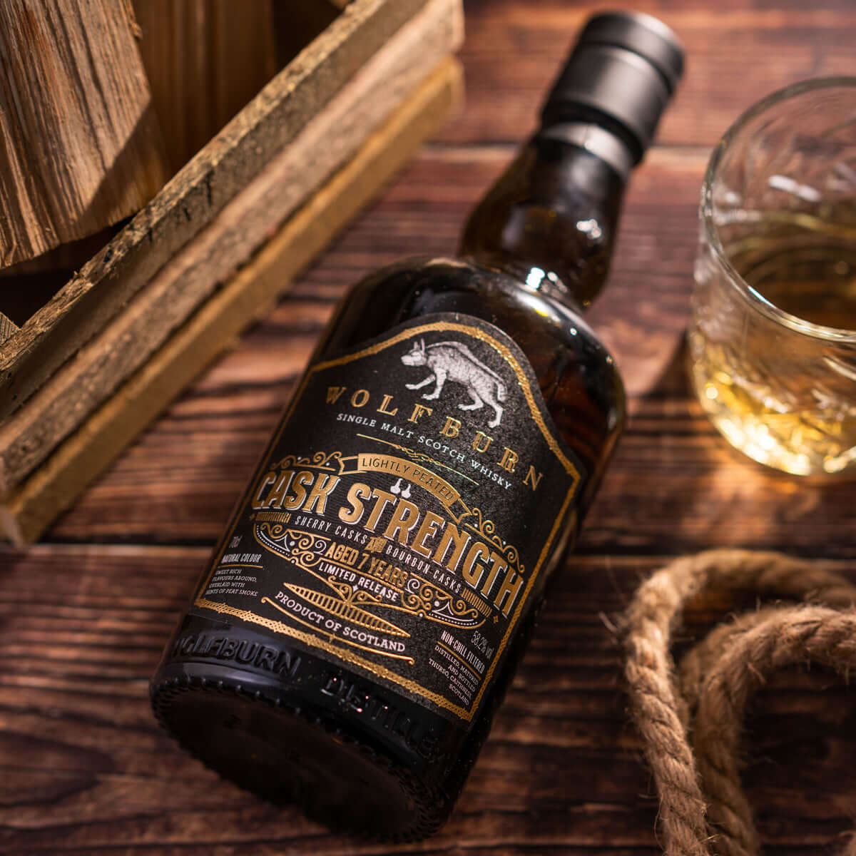 Cask Strength Single Malt Whisky bottle with glass, lightly peated, aged in bourbon and oloroso casks, handcrafted in Scotland.