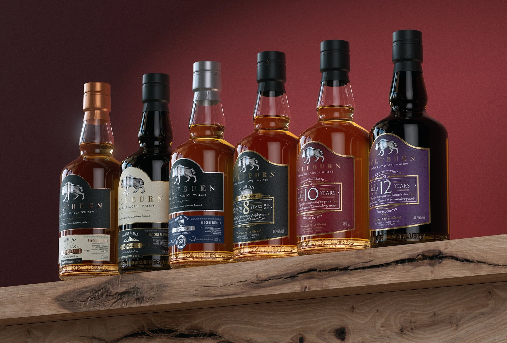 Row of whiskey bottles with labels on a wooden surface against a red background