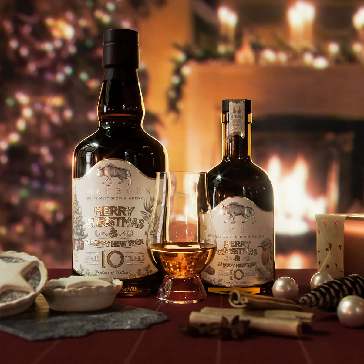 Wolfburn Christmas 10 Year Old Single Malt Scotch Whisky, limited release bottle with fire and tree in the background