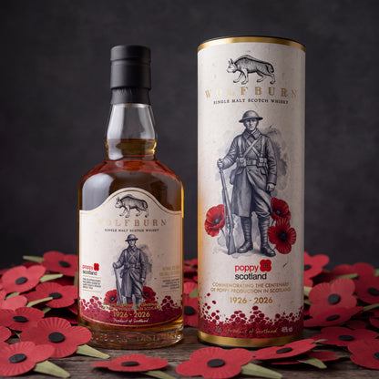 Wolfburn Poppyscotland 12 Year Old single malt Scotch whisky bottle and tube on a bed of Scottish poppies for remembrance day