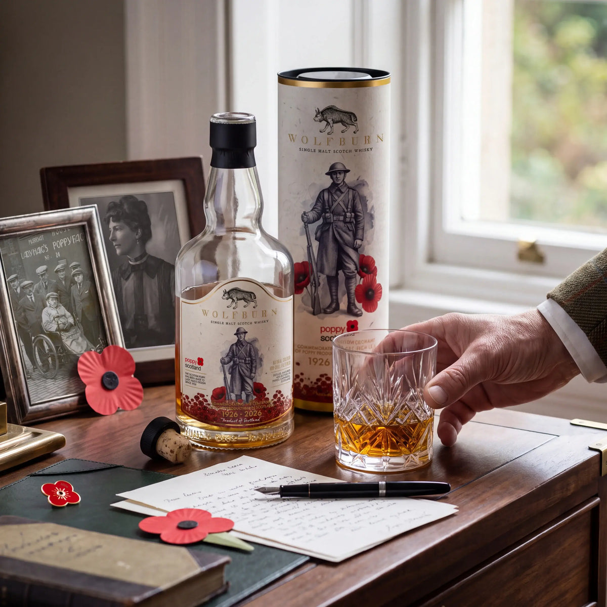 Limited edition Wolfburn Poppyscotland single malt scotch whisky beside old family photographs, Scottish poppies and a crystal glass for remembrance day