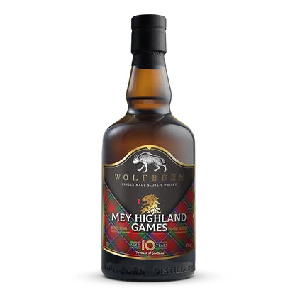 A bottle of Wolfburn 'Mey Highland Games' 10 Year Single Malt Scotch Whisky, featuring a dark amber glass bottle, black cap, and a label with a black background, white text, and red tartan Sinclair pattern.