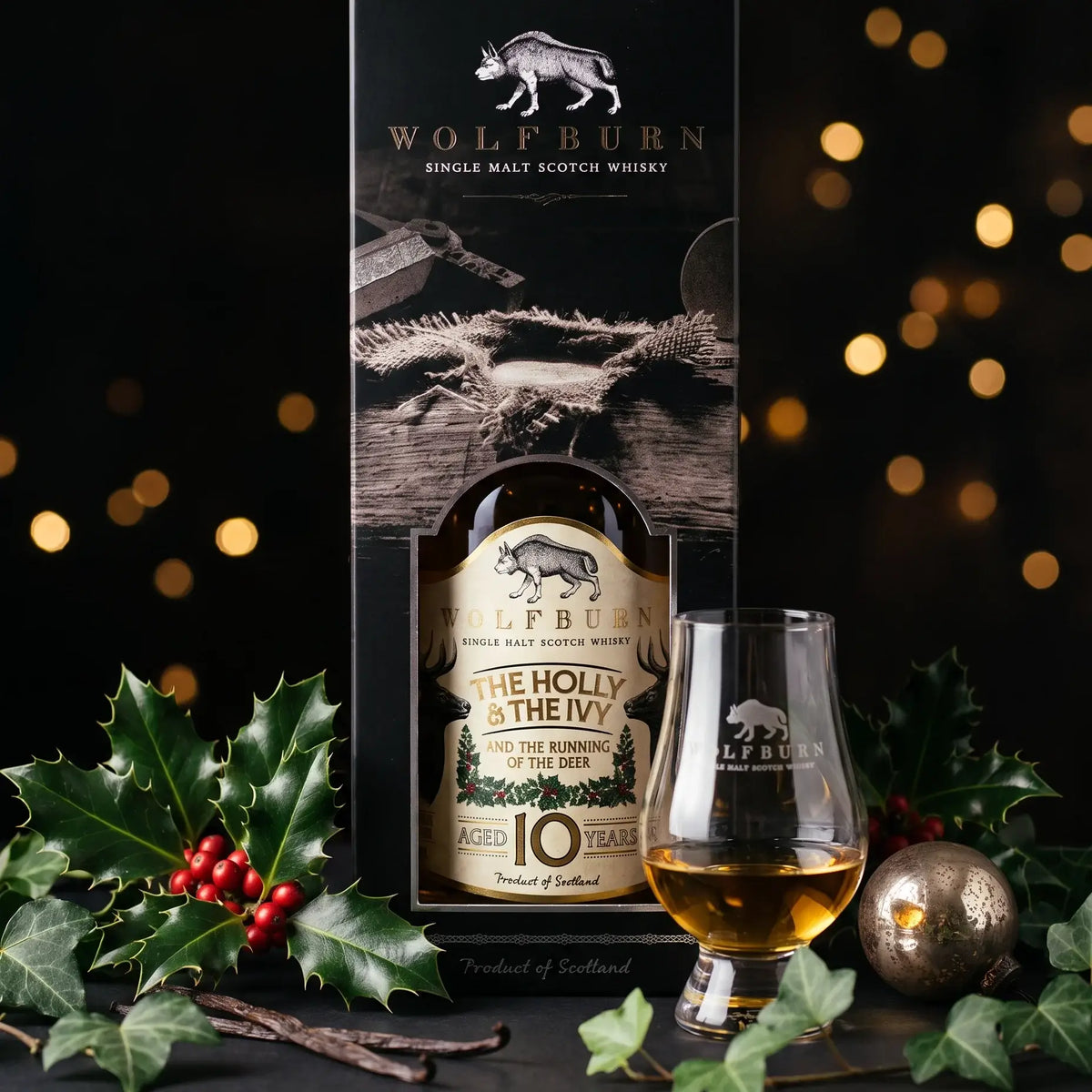 The Holly and The Ivy 10 Year Old in its black gift carton with a dram poured in a Wolfburn Glencairn glass