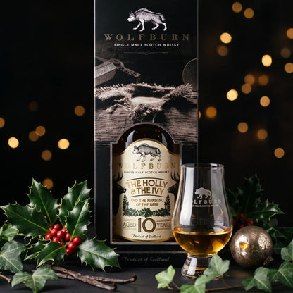 The Holly and The Ivy 10 Year Old in its black gift carton with a dram poured in a Wolfburn Glencairn glass