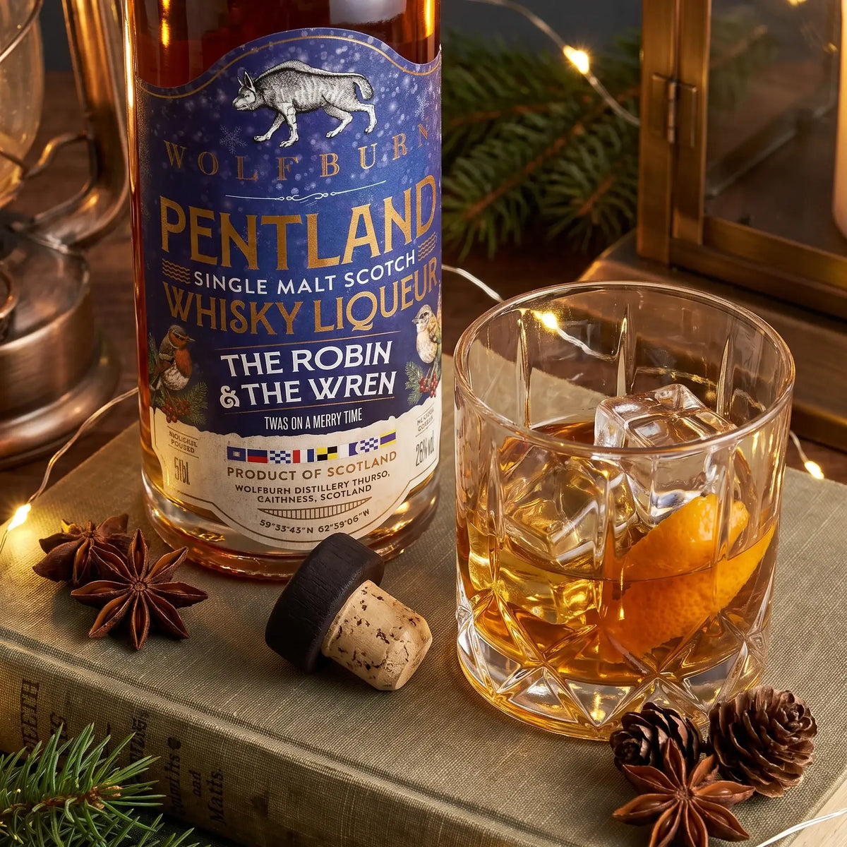 The Robin and The Wren Pentland Christmas whisky liqueur served over ice with orange peel, star anise and festive lights